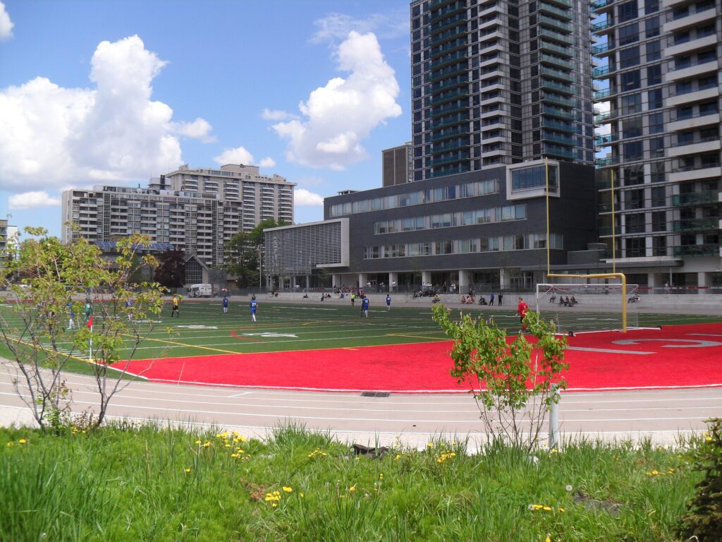 North Toronto Collegiate Institute and its sports field with apartment towers behind